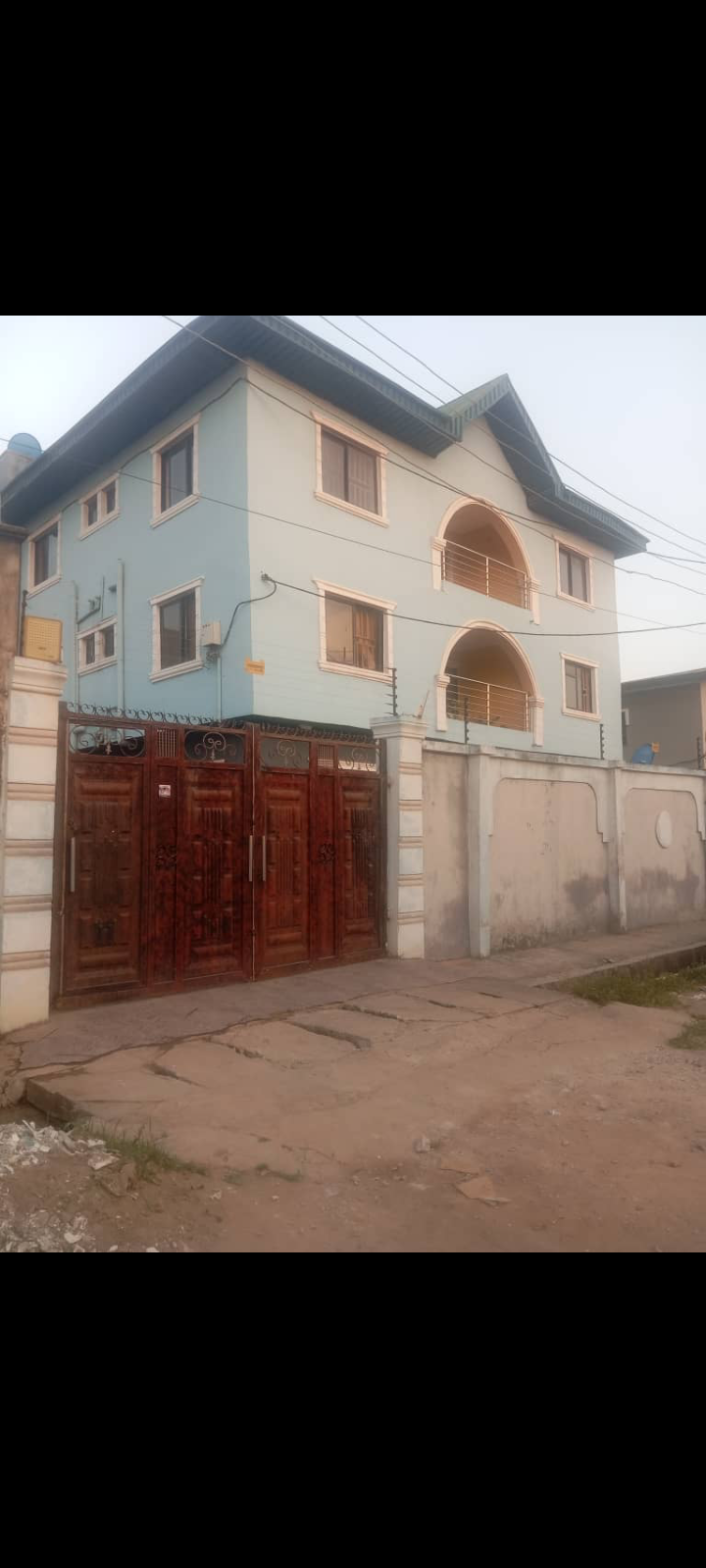 Full plot of land with 9 shops under decken By Grandmate b/stop off Ago palace Way,Okota, Lagos